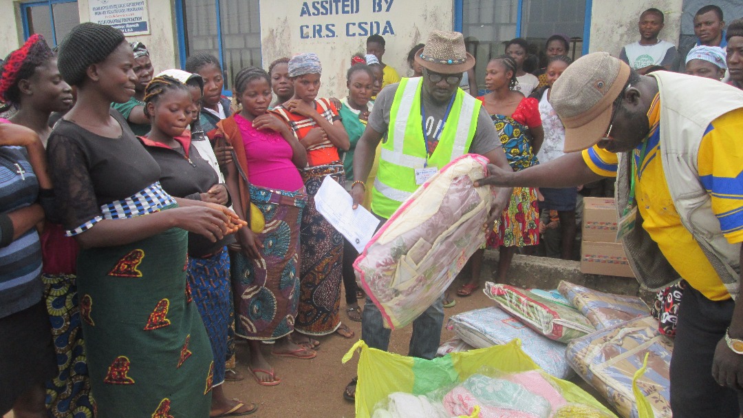 Pregnant refugees receiving warm clothing